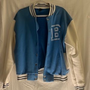 Varsity jacket,mostly blue/white along with black stripes on the sleeves/collar.